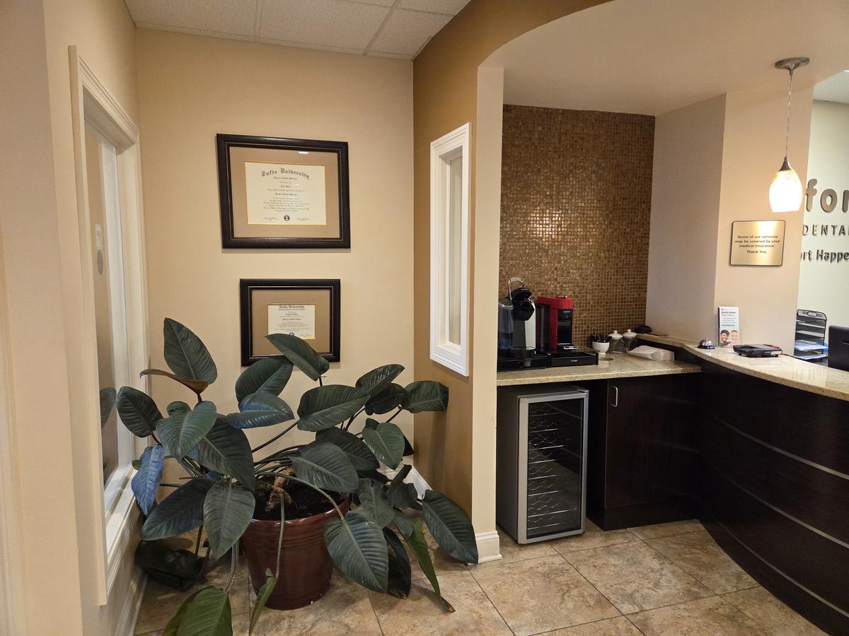 Coffee station beside Dr. Rowe's framed dental school diplomas at Comfort Family Dental